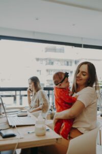 Working mother balancing work, sleep, and motherhood with a newborn