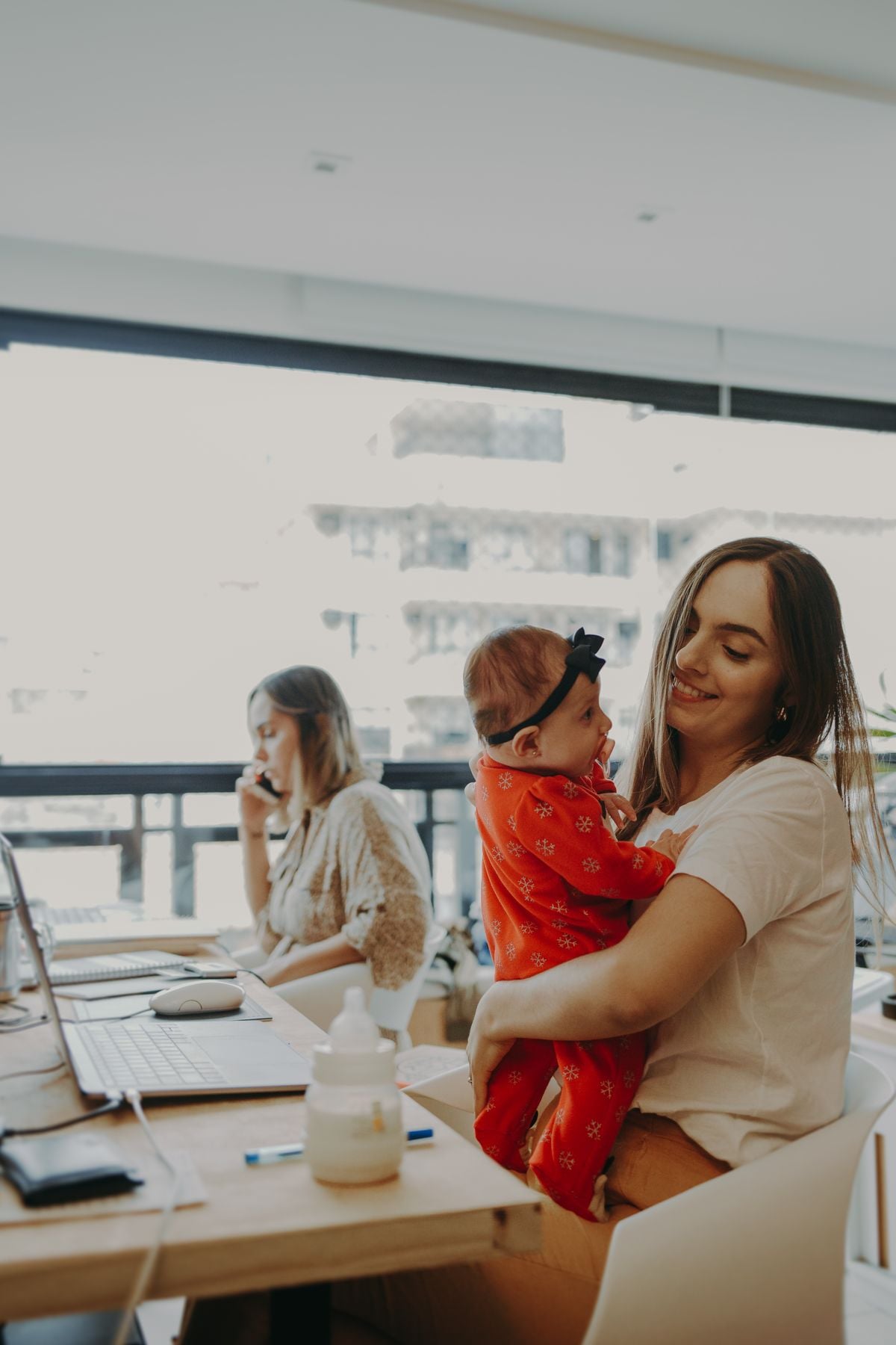 Working mother balancing work, sleep, and motherhood with a newborn